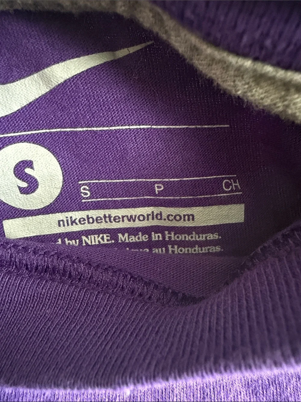 Nike Kids Purple Graphic Tee with White 'Unleash Speed' Logo